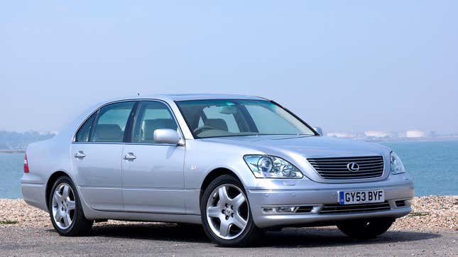 A silver Lexus LS 430 parked in front of water