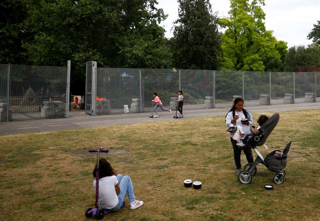 Visitors to the park use a special gate to pass through fences, that have been erected before the U.S. presidential visit at the end of the week, around the U.S. ambassador's residence in Regent's Park in London, Britain, July 10, 2018. REUTERS/Henry Nicholls - RC17948966D0