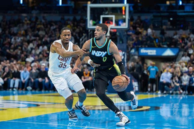 Nov 3, 2023; Indianapolis, Indiana, USA; Indiana Pacers guard Tyrese Haliburton (0) dribbles while Cleveland Cavaliers forward Isaac Okoro (35) defends in the first half at Gainbridge Fieldhouse.