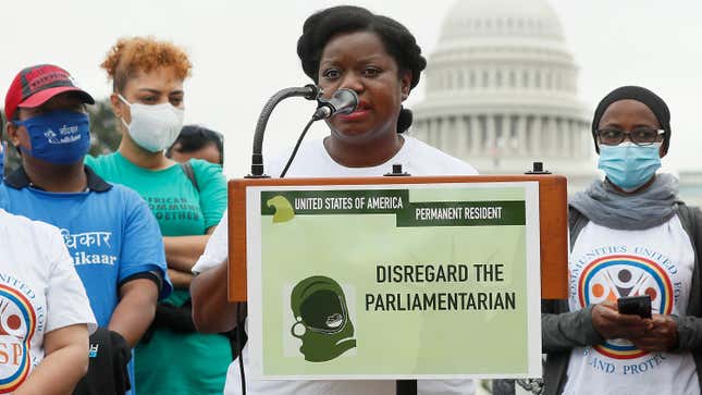  Guerline Jozef from Haitian Bridge Alliance speaks after immigrants installed hundreds of green card placards symbolizing their demand for U.S. citizenship at a rally in front of the U.S. Capitol Building in Washington, DC.