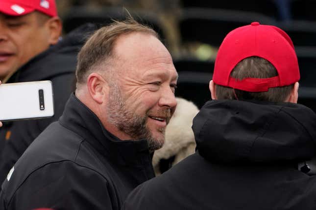 FILE - Alex Jones, left, attends a rally in support of President Donald Trump called the &quot;Save America Rally,&quot; on Jan. 6, 2021, in Washington. Elon Musk has restored the X account of conspiracy theorist Alex Jones following a poll posted on the social media platform formerly known as Twitter on Saturday Dec. 9, 2023 that came out in favor of the Infowars host who repeatedly called the 2012 Sandy Hook school shooting a hoax. (AP Photo/Jacquelyn Martin, File)