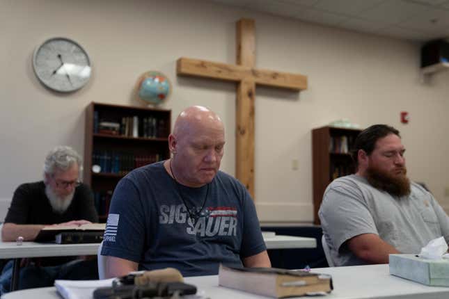 Brian Wright, center, prays during bible study at Gospel Rescue Mission, Thursday, March 21, 2024, in Grants Pass, Ore. (AP Photo/Jenny Kane)