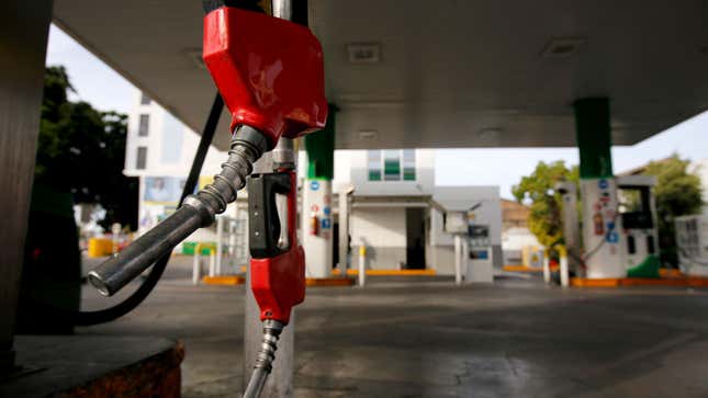 A gas pump hangs free at a filling station. 