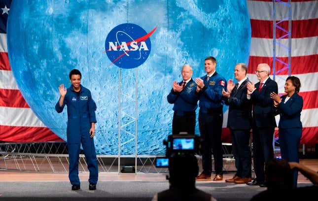 NASA astronaut Jessica Watkins (L) waves at the audience during during the astronaut graduation ceremony at Johnson Space Center in Houston Texas, on January 10, 2020. 