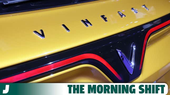 A photo of the VinFast logo on the rear of a yellow car. 