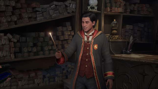 A Gryffindor student holds a lit wand.