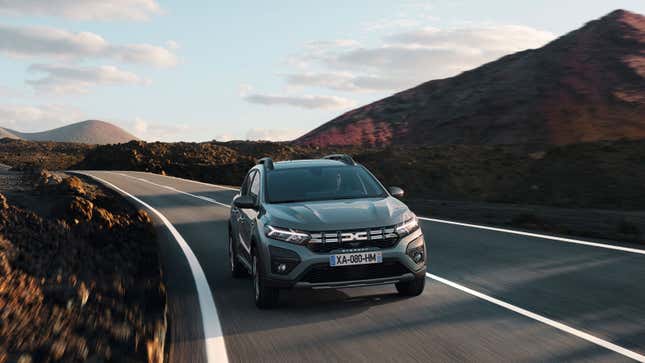 A photo of a Dacia Sandero hatchback driving on a road. 