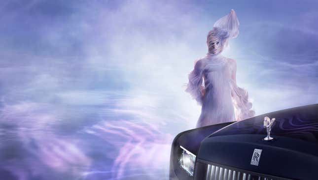 A model in an Iris van Herpen gown posing in front of a Rolls-Royce
