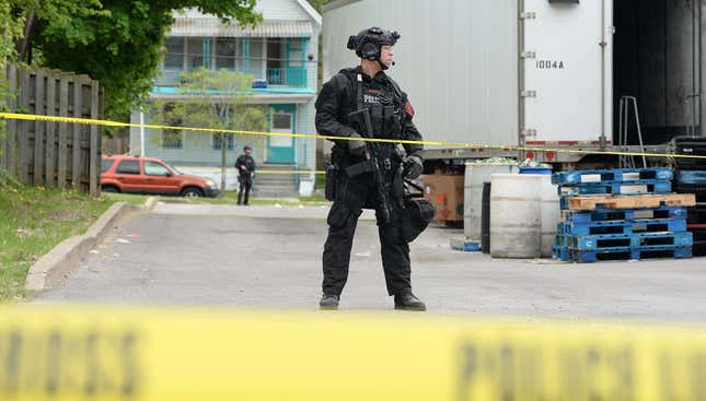 A heavily-armed cop guarding what appears to be the backside of the Tops Friendly Market in Buffalo, New York.