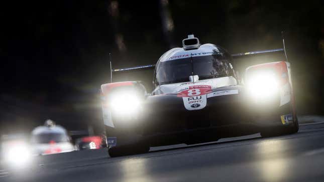 A photo of two endurance cars racing at Le Mans. 