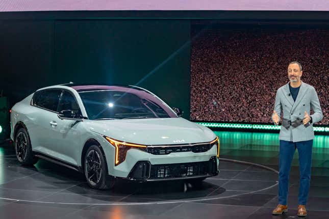 Karim Habib, KIA head of global design, stands with KIA&#39;s new K4 model at the 2024 New York International Auto Show, Wednesday, March 27, 2024, in New York. (AP Photo/Peter K. Afriyie)