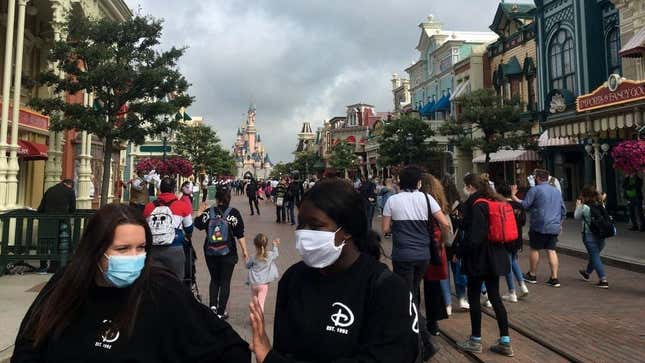 Guests in face masks visiting Disneyland Paris in June 2020.