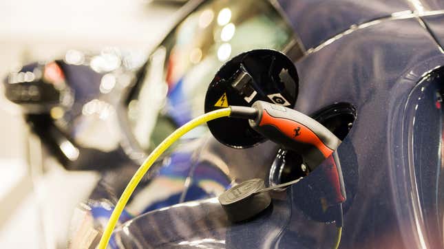 An electric charging plug in a Ferrari NV SF90 hybrid vehicle on the opening day of the Paris Motor Show in Paris, France, on Monday, Oct. 17, 2022.