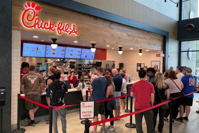 FILE -People line up to order fast food from a Chick-fil-A restaurant at the Iroquois Travel Plaza rest stop on the New York State Thruway in Little Falls, New York, on Friday, June 30, 2023. New York lawmakers have introduced a bill that would require restaurants in state highway system rest areas to operate seven days a week, a measure apparently aimed at interfering with a policy at the fast food chain Chick-fil-A of staying closed on Sundays. (AP Photo/Ted Shaffrey, File)