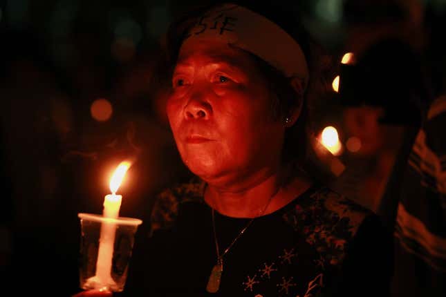 A participant looks on as she and others mourn those killed during military crackdown on pro-democracy movement in Beijing, at Hong Kong's Victoria Park