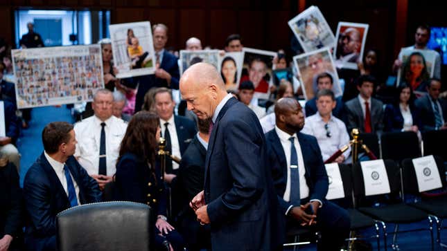 Boeing CEO Dave Calhoun returns to his seat after speaking directly to family members of those killed in the Ethiopian Airlines Flight 302 and Lion Air Flight 610 crashes during his testimony before the U.S. Senate.