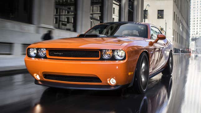 A photo of an orange Dodge Challenger muscle car. 