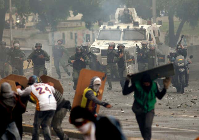 Bolivarian National Guards charge on anti-government demonstrators