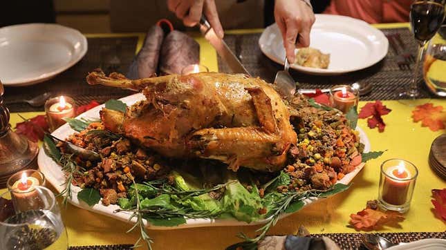 Person carving traditional Thanksgiving turkey