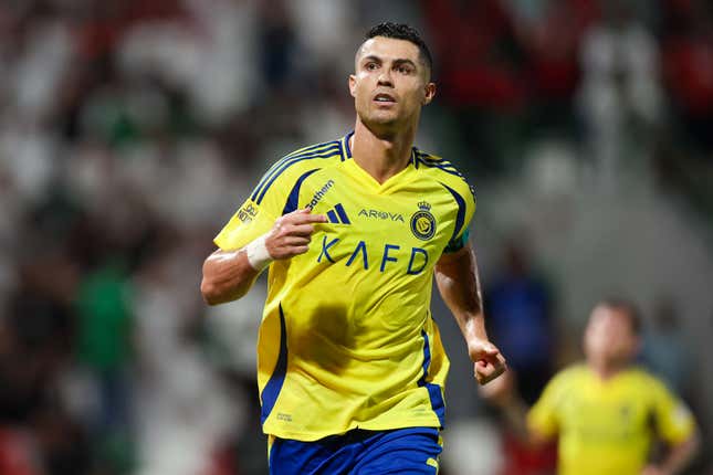 Cristiano Ronaldo running, wearing a bright yellow jersey and royal blue shorts