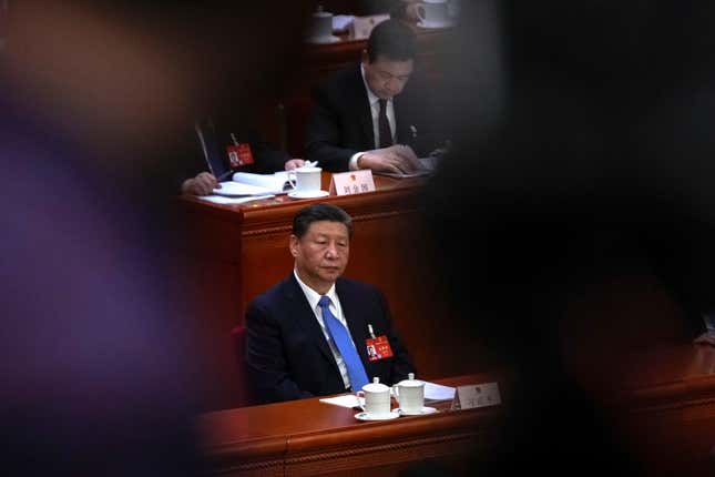 A cameraman films Chinese President Xi Jinping attending the second plenary session of the National People&#39;s Congress (NPC) at the Great Hall of the People in Beijing, Friday, March 8, 2024. (AP Photo/Andy Wong)