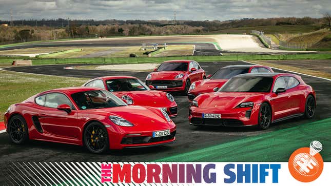 A photo of five red Porsche cars at a race track. 