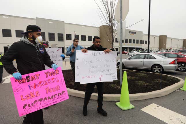Protesters hold signs saying "Treat your workers like your customers" and "Alexa Please Shutdown and Sanitize the building?" during a March 2020 protest at the Staten Island warehouse.