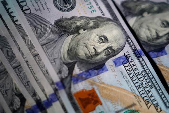 FILE - The likeness of Benjamin Franklin is seen on U.S. $100 bills, Thursday, July 14, 2022, in Marple Township, Pa. In preparation for 2024, you can shore up your finances by creating some financial New Year’s resolutions for yourself. (AP Photo/Matt Slocum, File)