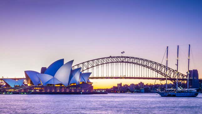 a photo of sunset over the Sydney Harbour Bridge in Australia. 