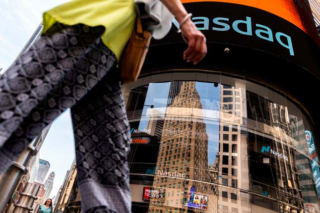 FILE - People walk past the Nasdaq MarketSite, July 13, 2022, in New York. A Dubai sovereign wealth fund that&#39;s the single-largest shareholder in the Nasdaq stock index plans to sell a third of its shares in the exchange, a deal potentially worth some $1.6 billion that saw the value of the firm fall in aftermarket trading Wednesday, March 20, 2024. (AP Photo/Julia Nikhinson, File)