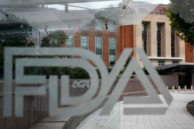 FILE - A U.S. Food and Drug Administration building is seen behind FDA logos at a bus stop on the agency&#39;s campus in Silver Spring, Md., on Aug. 2, 2018. Federal health advisers voted against an experimental treatment for Lou Gehrig’s disease at a Wednesday, Sept. 27, 2023, meeting prompted by years of patient efforts seeking access to the unproven therapy. (AP Photo/Jacquelyn Martin, File)