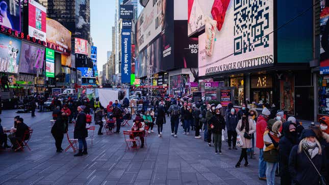 People queue at a street-side covid-19 testing booth in New York’s Times Square on December 20, 2021.