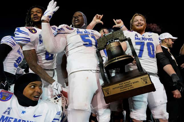 FILE - Memphis offensive linemen Terrance McClain (51) and Jacob Likes (70) celebrate after the team&#39;s win against Iowa State at the Liberty Bowl NCAA college football game Friday, Dec. 29, 2023, in Memphis, Tenn. FedEx on Friday, April 19, 2024, pledged $25 million over the next five years to be used in sponsorship deals with University of Memphis athletes, a huge boost for the school&#39;s name, image and likeness compensation efforts.(AP Photo/George Walker IV, File)