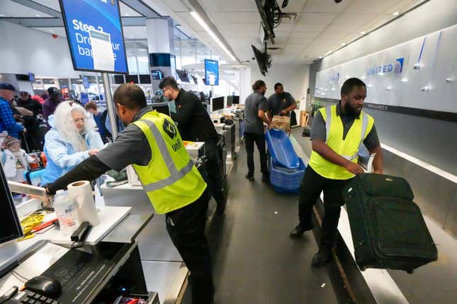 FILE - Passenger drop off their baggage at United Airlines in C Terminal at George Bush Intercontinental Airport, Thursday, Dec. 21, 2023, in Houston. The Biden administration issued final rules Wednesday, April 24, 2024, to require airlines to automatically issue cash refunds for things like delayed flights and to better disclose fees for baggage or canceling a reservation. (Brett Coomer/Houston Chronicle via AP, File)