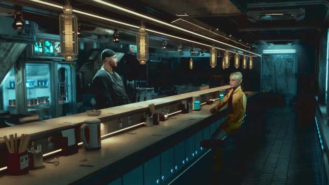 A man stands behind a ramen bar and a woman sits on the other side.