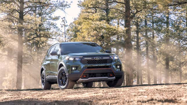 A photo of a Ford SUV in the woods. 