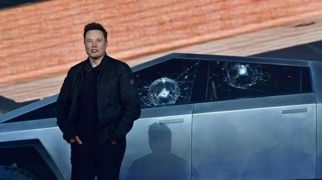 Tesla co-founder and CEO Elon Musk stands in front of the shattered windows of the newly unveiled all-electric battery-powered Tesla's Cybertruck at Tesla Design Center in Hawthorne, California on November 21, 2019.