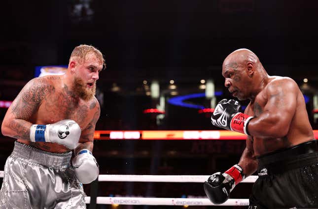 Jake Paul, left and Mike Tyson fight during LIVE On Netflix: Jake Paul vs. Mike Tyson at AT&amp;T Stadium on November 15, 2024 in Arlington, Texas.