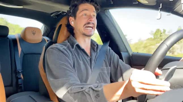 A screenshot of me making a stupid face driving the maserati Ghibli Ultima