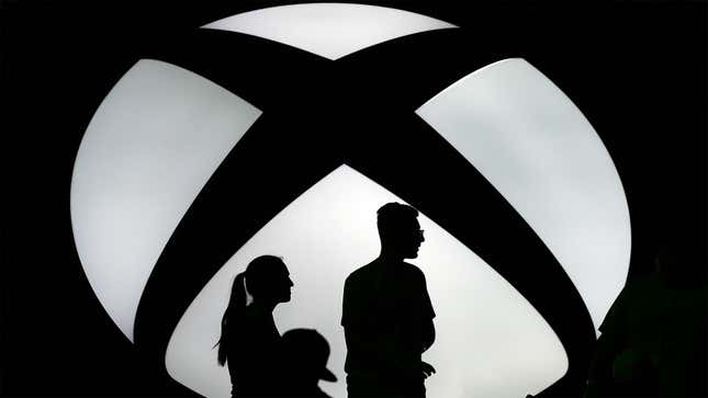An image of shadowy figures within an illuminated Xbox logo.