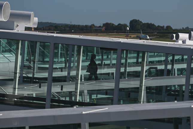 A woman boarding a plane on an airbridge at Paris Charles de Gaulle Airport, on August 14, 2023, in Roissy-en-France, France. 