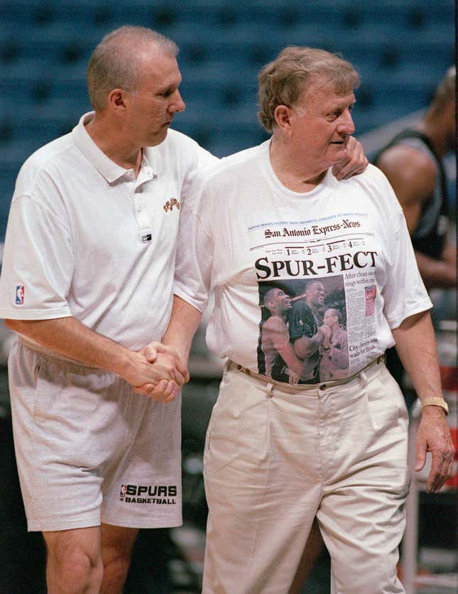 FILE - San Antonio Spurs head coach Greg Popovich, left, shakes hands with San Antonio businessman and former Spurs owner Red McCombs, Saturday, June 12, 1999, during the Spurs&#39; practice at the Alamodome in San Antonio, Texas. The McCombs family has purchased a share of the San Antonio Spurs, returning after 30 years to the organization their patriarch helped establish and once owned. (William Luther/The San Antonio Express-News via AP, File)