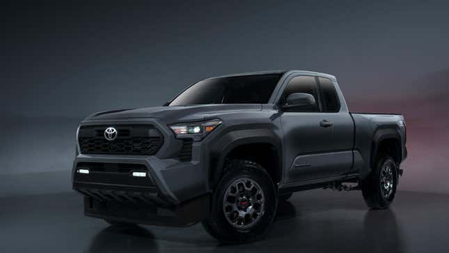 A dark gray Toyota Tacoma from the front 3/4 in a studio 