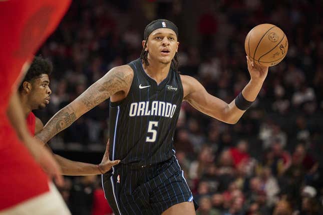 Oct 27, 2023; Portland, Oregon, USA; Orlando Magic forward Paolo Banchero (5) passes the ball during the second half against Portland Trail Blazers guard Scoot Henderson (00) at Moda Center.