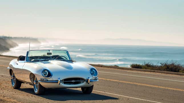 A photo of a Jaguar E-Type on the beach. 