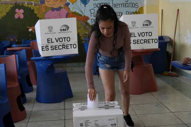 A woman votes in a runoff presidential election in Quito, Ecuador, Sunday, Oct. 15, 2023. (AP Photo/Dolores Ochoa)