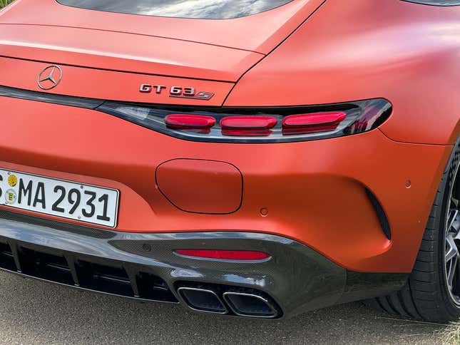 Rear charge port and taillight of an orange 2025 Mercedes-AMG GT63 S E Performance