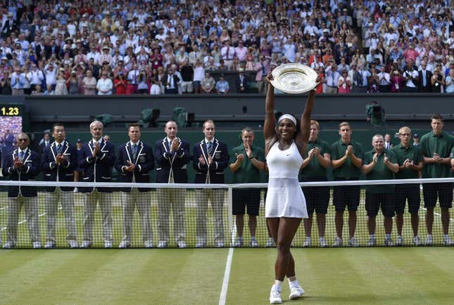 Victorious again. Williams holds up the Wimbledon ladies championship trophy and garners the £1.88m ($2.7m) prize.