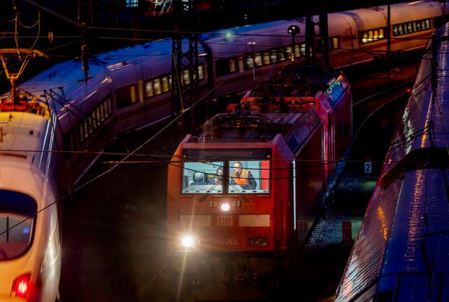 FILE - Two train drivers sit in the cockpit of a parked train outside the central train station in Frankfurt, Germany, Tuesday, Jan. 23, 2024. Train drivers and some other train crew for Germany’s main national railway operator will see their working week reduced from 38 hours to 35 by 2029 without having their pay cut, but will have an option to work longer for more money, the two sides say. (AP Photo/Michael Probst, File)