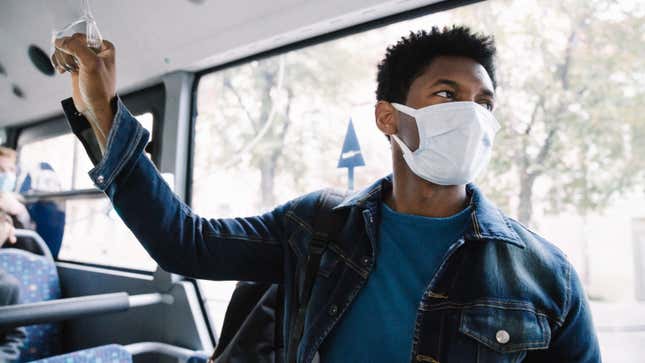 Photograph of a Man Wearing Mask At Public Transport